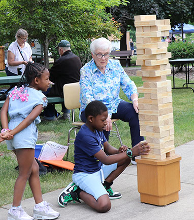 Sister Fran playing Giant Jenga with kids