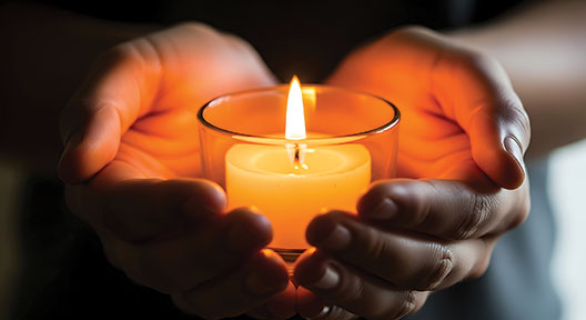 hands holding a candle